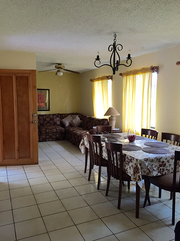 Living Dining area. Table and 6 chairs and a sectional sofa.